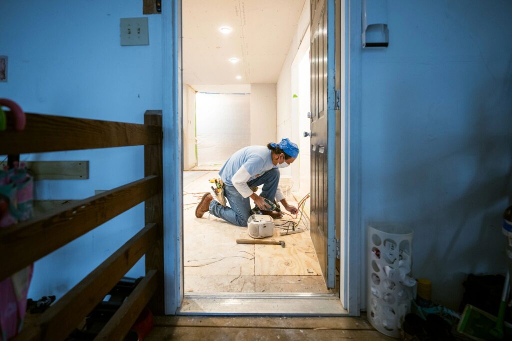 Drywall installers working in kitchen renovation